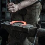 red hot horseshoe on anvil