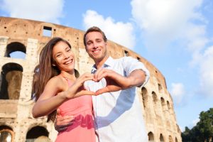 Young couple make a "love" sign in Rome