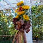 white wooden arbor with sunflowers and butterfly