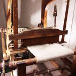 Old antique wooden manual weaving machine. Retro manufacturing.